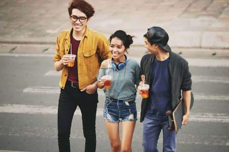 Asian Friends Crossing Streetの写真素材