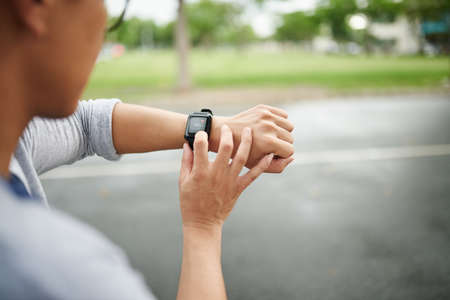 Hands of man checking heart rate on smart watchの写真素材