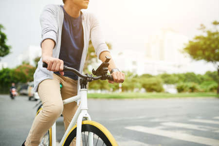 Cropped image of man enjoying bicycle ride in the cityの写真素材