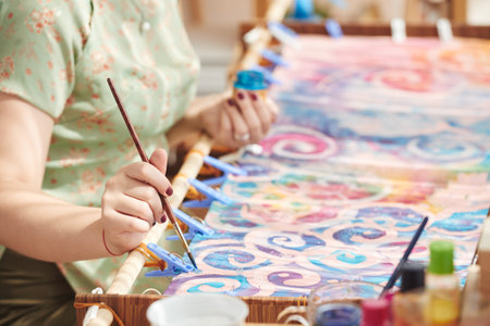 Close-up image of woman painting on stretched canvasの写真素材
