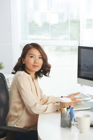 Confident businesswoman at workplaceの写真素材