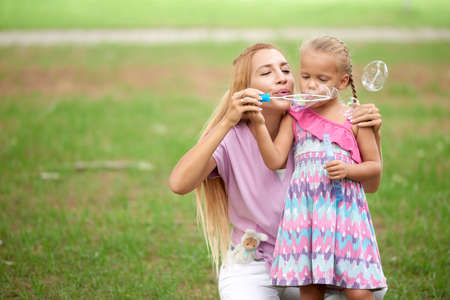 Soap bubbles playing in the parkの写真素材