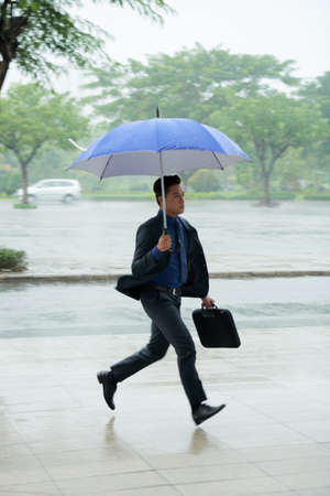 Asian Businessman Running Lateの写真素材