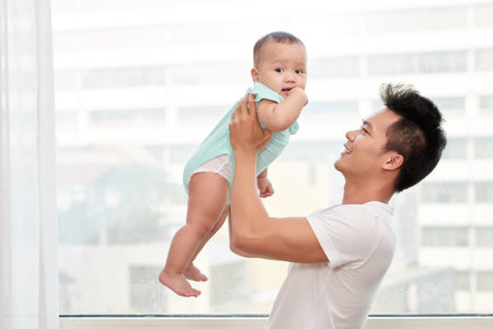 Happy father holding baby