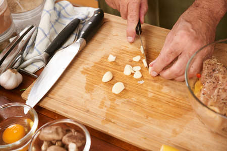 Man preparing meal in the kitchenの写真素材
