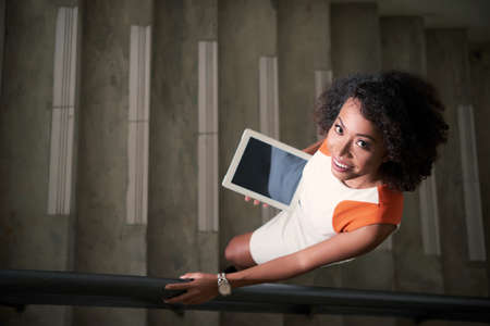 Business woman with digital tablet on the stairsの写真素材