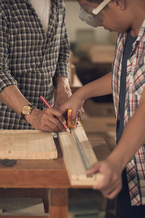 Measuring wooden plankの写真素材
