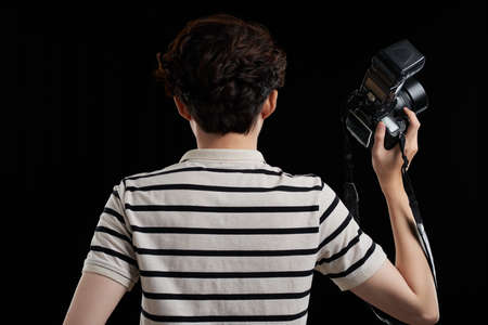 Rear view of professional photographer with digital cameraの写真素材