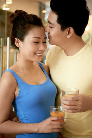 Asian young couple in love enjoying fresh juiceの写真素材