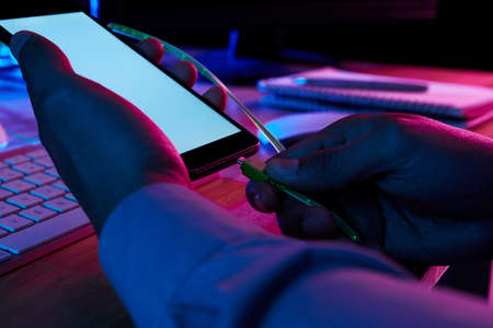 Programmer connecting smartphone with computerの写真素材