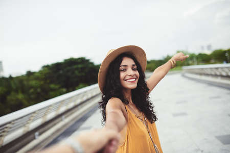 Attractive Hispanic young woman enjoying walking on the bridgeの写真素材