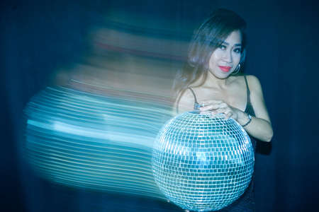 Young lady enjoying nightlife at discoの写真素材