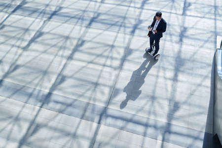 Businessman riding on gyroscooter in the streetの写真素材