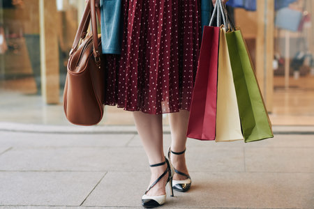 Legs of female shopaholic with many paper-bagsの写真素材