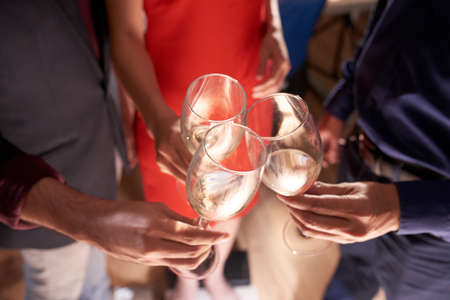 People clinking with glasses of champagne at party, view from aboveの写真素材