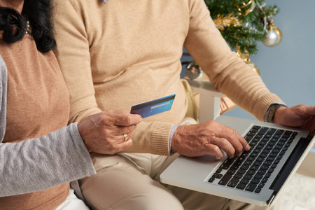 Elderly couple making online purchases for Christmasの写真素材