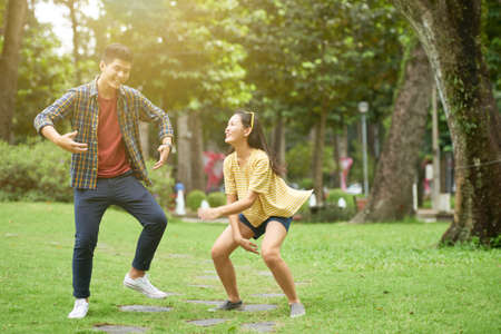 Asian young couple dancing in the parkの写真素材