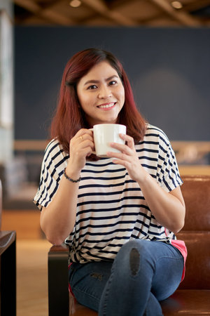 Lovely pretty smiling woman with cup of coffee