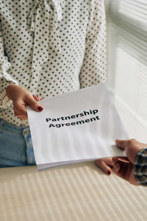 Partnership agreement in hands of business peopleの写真素材