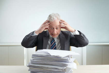 Portrait of Senior Businessman Overwhelmed by Workの写真素材