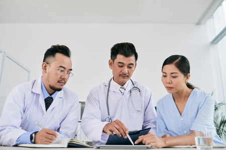 Vietnamese medical workers discussing analysis results of the patient