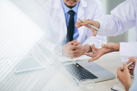 Hands of medical workers having discussion in the officeの写真素材