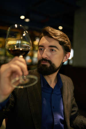 Examining red wineの写真素材