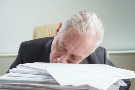 Man fall asleep from Tired of workの写真素材