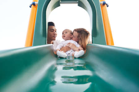 On playground with parentsの写真素材