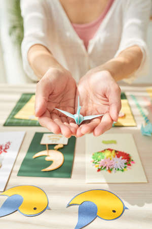 Female Hands Holding Origami Craneの写真素材