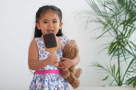 Small girl holding teddy bearの写真素材