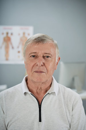 Portrait of senior man in office of doctorの写真素材