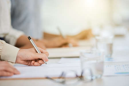 Hand of business lady signing agreement at meetingの写真素材