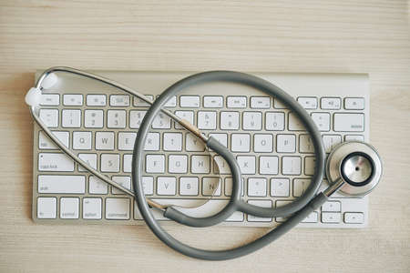 Stethoscope on computer keyboard, view from aboveの写真素材