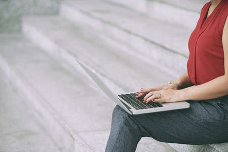 Cropped image of business woman aswering e-mailsの写真素材