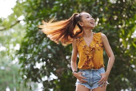 Happy attractive Vietnamese woman having fun outdoorsの写真素材