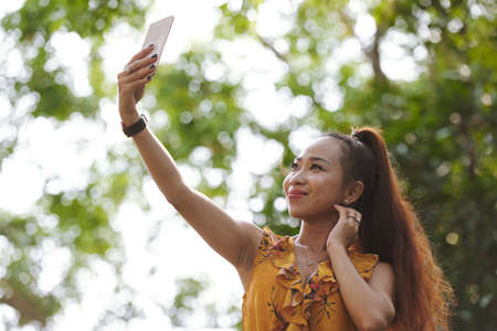 Beautiful Vietnamese young woman posing for selfieの写真素材