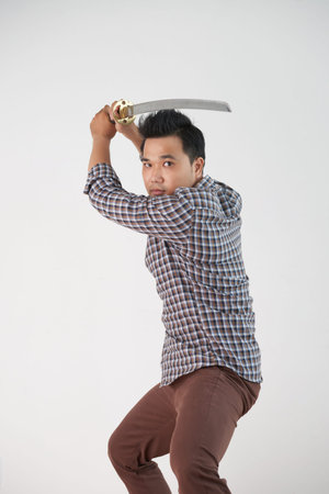 Young Asian man fighting with katana swordの写真素材