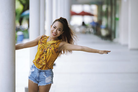Young cheerful woman enjoying her time outdoorsの写真素材