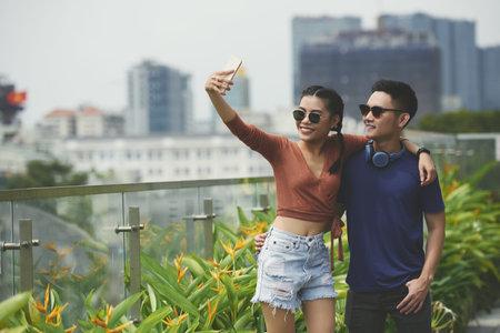 Young couple taking photosの写真素材