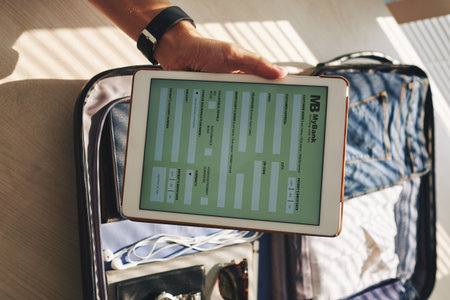 Close-up of businessman paying by online bank from his touchpadの写真素材