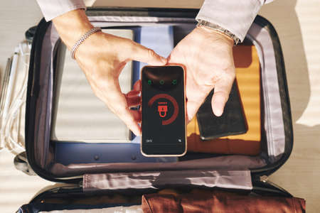 Close-up of male hands holding  locked smartphoneの写真素材