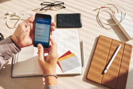 Man checking an account in an online bank on his smartphone