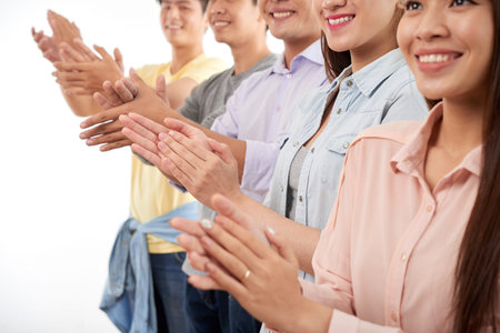 Cheerful clapping young peopleの写真素材