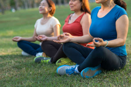 Cropped image of three meditating elderly womenの写真素材