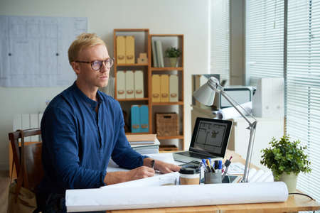 Professional young architect working in his bureauの写真素材