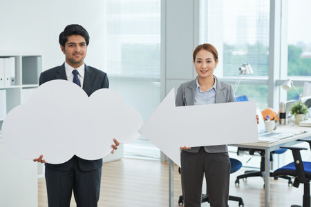 Portrait of business people holding signs at office