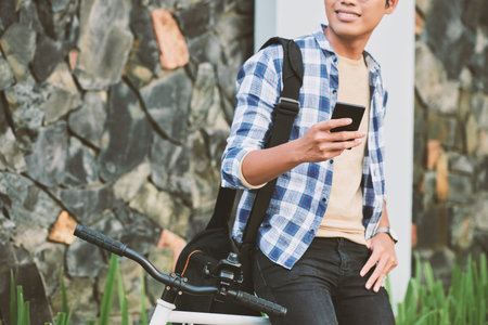 Young man texting to friend