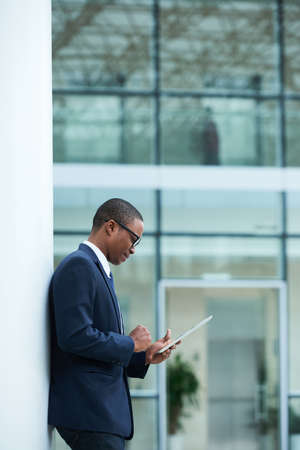 Businessman checking e-mails on digital tabletの写真素材
