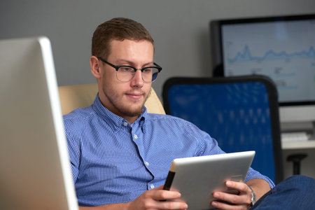 Entrepreneur reading data on tablet screen